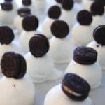 white chocolate oreo balls topped with mini oreo cookies