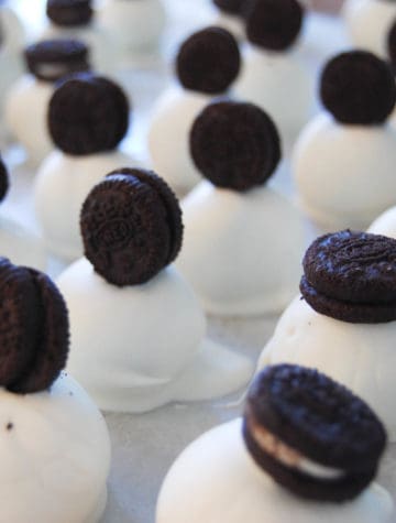white chocolate oreo balls topped with mini oreo cookies