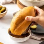 french dip sandwich in bowl of au jus
