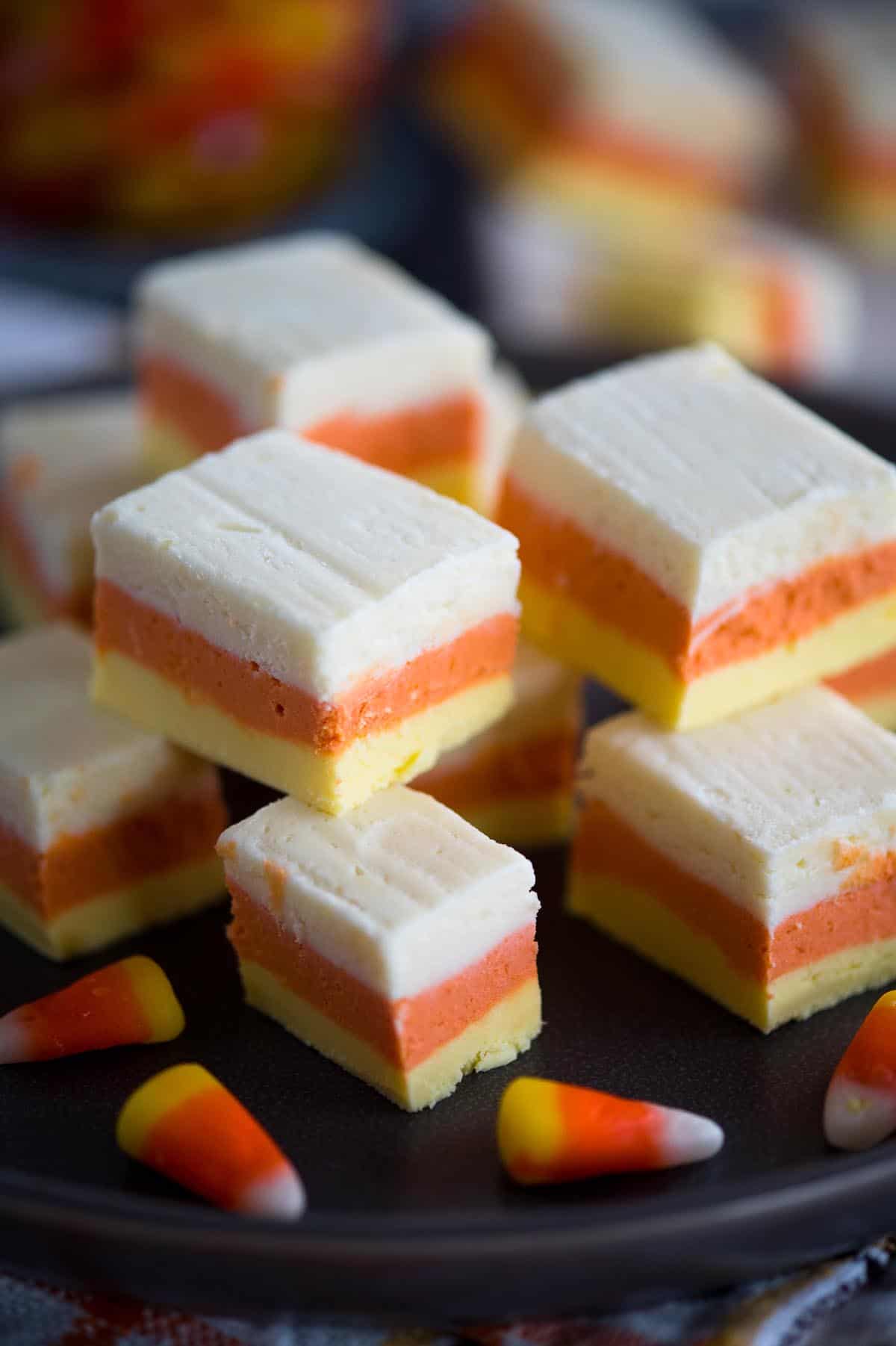 plate of fudge squares with white, orange and yellow candy corn layers