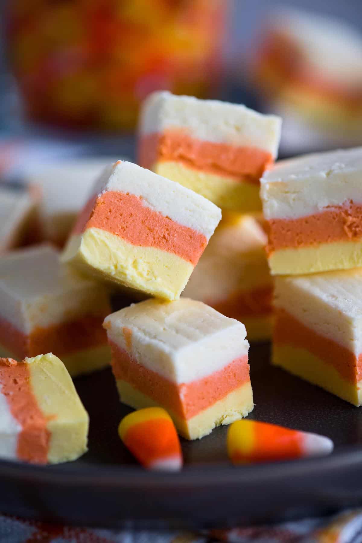 candy corn fudge on a plate with white orange and yellow layers