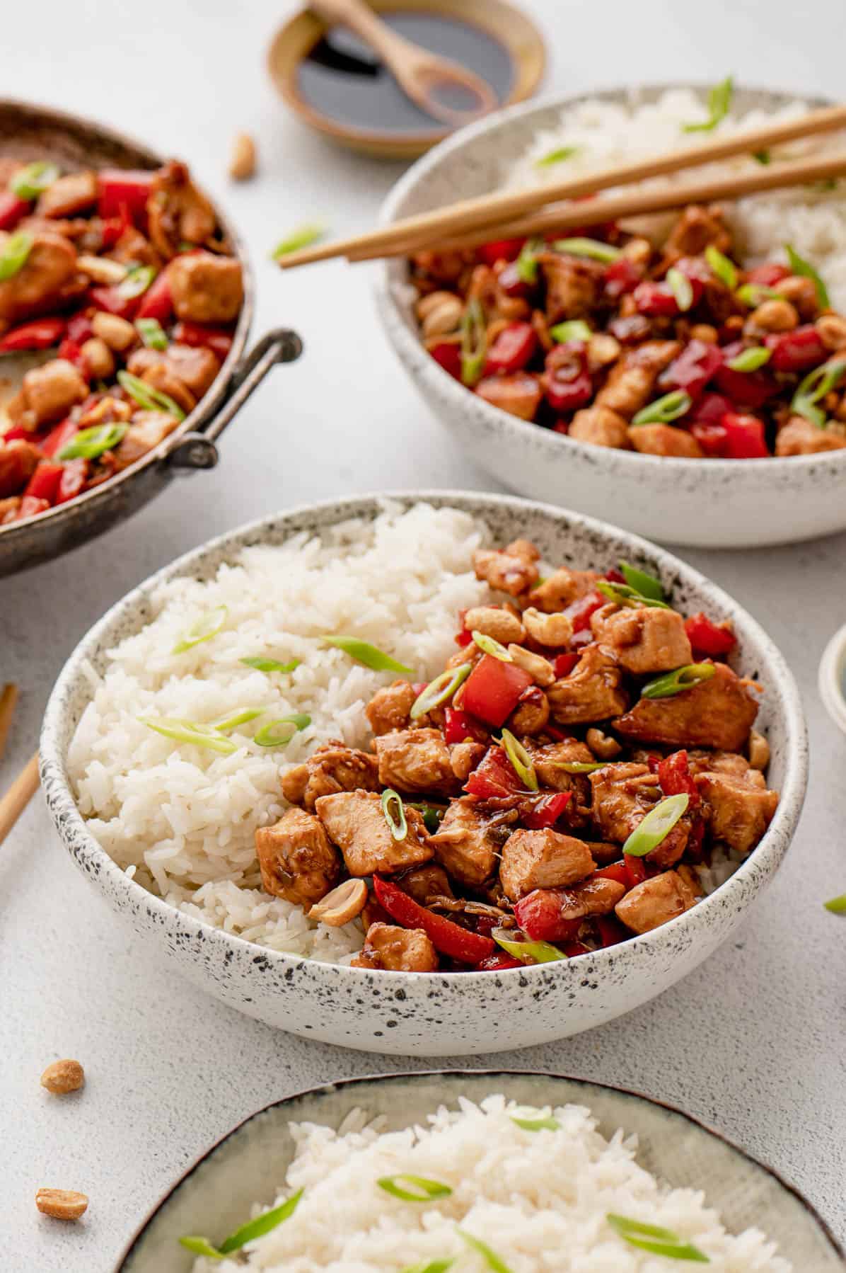 bowls of white rice and kung pao chicken