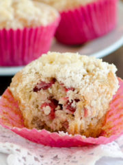 bite out of a strawberry banana muffin with streusel topping