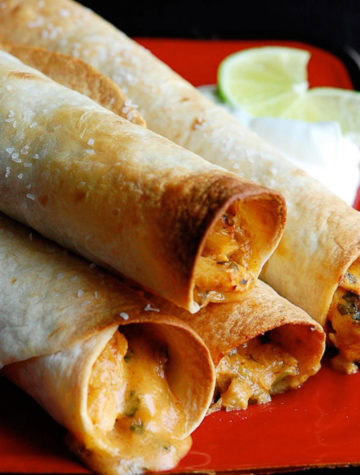 rolled taquitos stacked on a plate