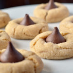 Classic Peanut Butter Blossoms are the epitome of the holidays! Peanut butter cookies rolled in sugar and topped with Hershey's Chocolate Kisses are the perfect cookies for a Christmas cookie exchange. Of course, you can enjoy these Peanut Butter Blossoms round!