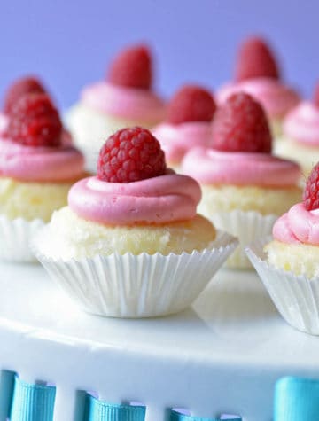 lemon cupcakes topped with raspberry frosting and a raspberry