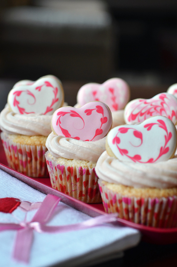strawberry cupcakes topped with sugar cookie hearts
