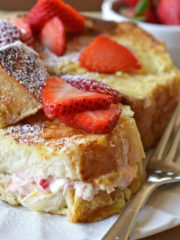 french toast stuffed with cream cheese and strawberry filling and topped with strawberry slices