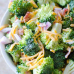 A fresh crisp broccoli salad tossed with a simple tangy homemade dressing. Broccoli salad is a quick salad everyone loves for any gathering, potluck, party, etc.