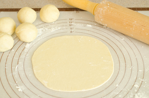 Tortillas Rolled Dough and dough balls on pastry sheet