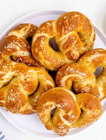 plate of salted soft pretzels with a side of yellow mustard