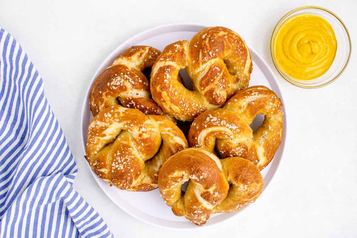 soft pretzels on a plate with a side of mustard