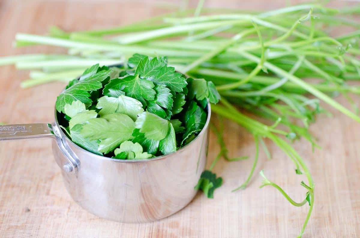 fresh parsley leaves in a measuring cup
