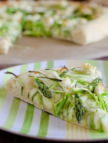 slice of pizza topped with shaved asparagus