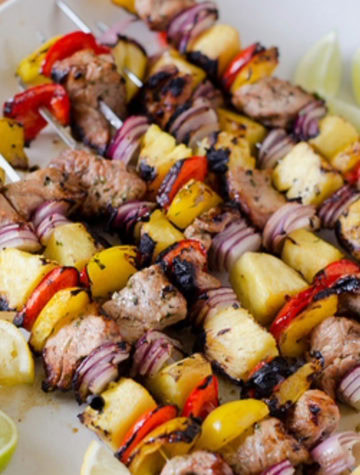 pork and pineapple kebabs on a large platter