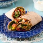 flatbread wrap with veggies on a blue plate
