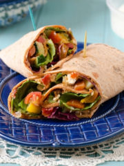 flatbread wrap with veggies on a blue plate