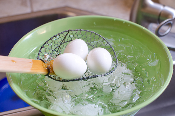 hard boiled eggs in bowl with ice water