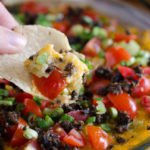 Baked Southwestern Chile Dip is a super easy dip that can be prepped up to 4 hours in advance. Throw in the oven for only 20 minutes before topping with fresh tomatoes and green onions.