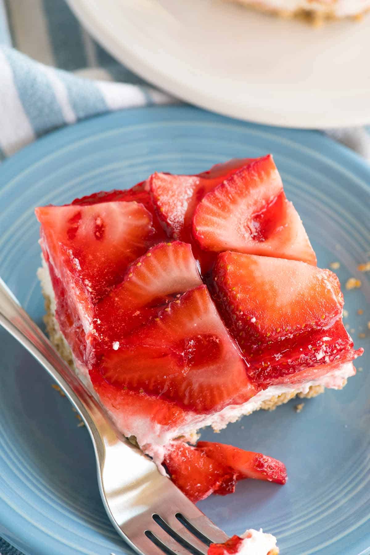 strawberry dessert on a blue plate with fork