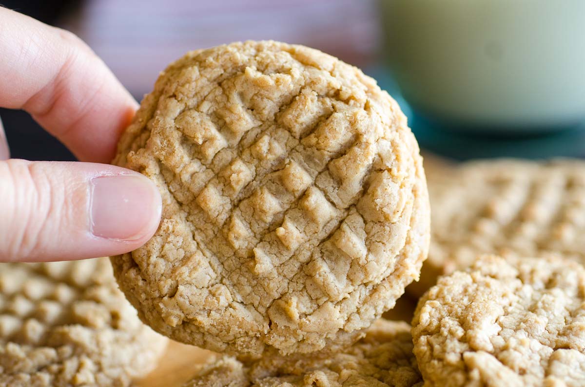 fingers holding peanut butter cookie