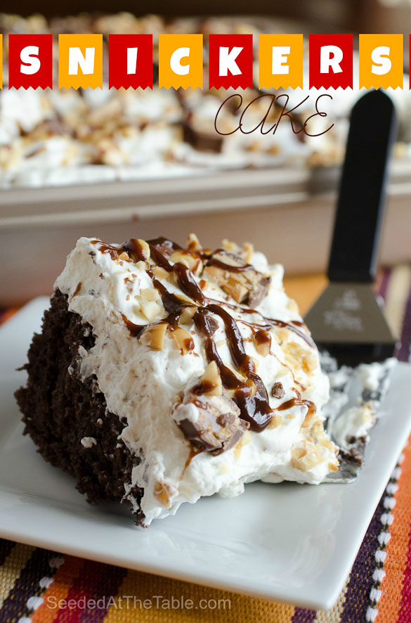 Snickers Cake is a dessert to please a crowd.  Boxed cake mix is the base for this Snickers Cake that is then soaked in caramel sauce and garnished with a whipped Snickers topping.