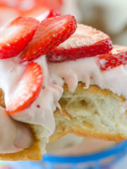 fluffy strawberry donut with topped with strawberry icing and strawberry slices