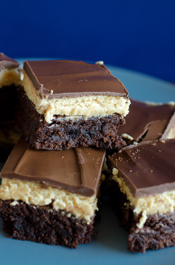 These Buckeye Brownies feature fudge brownie as the base, layered with a traditional peanut butter Buckeye filling and a smooth chocolate topping.