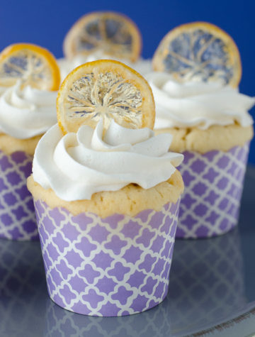 These zesty lemon cupcakes are topped with a fluffy vanilla cream frosting and crispy lemon peels.