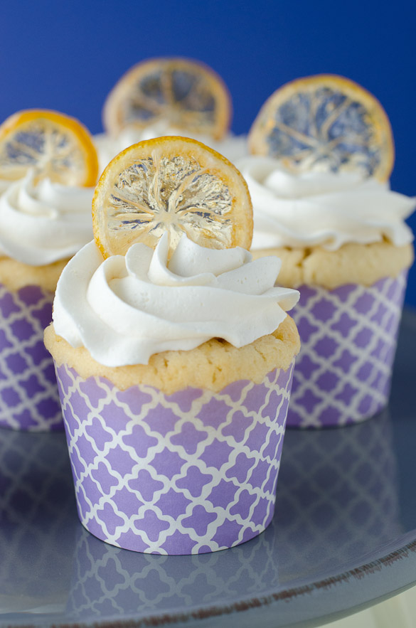 These zesty lemon cupcakes are topped with a fluffy vanilla cream frosting and crispy lemon peels.