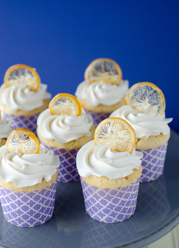 These zesty lemon cupcakes are topped with fluffy vanilla cream frosting and a crispy candied lemon peel.