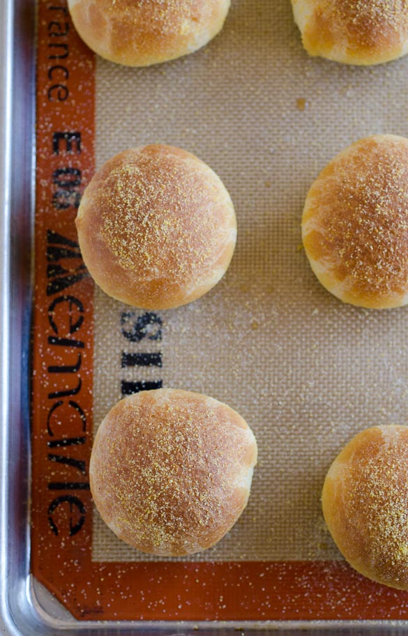 Cornbread rolls on baking sheet.