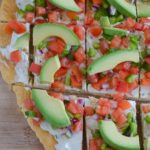 This Fresh Salsa and Cream Cheese Pizza is a perfect lunch or party appetizer. Freshly made salsa is sprinkled over top a layer of garlic-infused cream cheese with a crust made from refrigerated crescent dough.