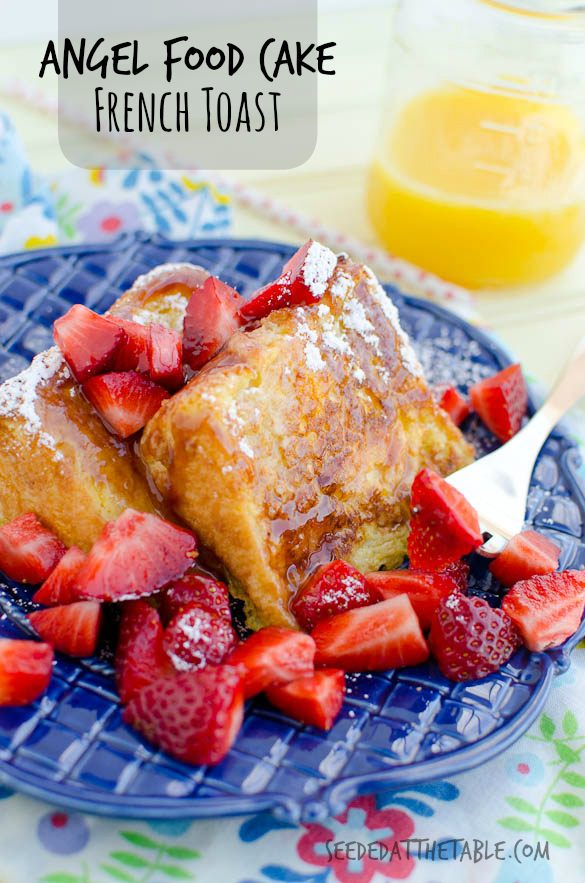 Slices of Angel Food Cake French Toast with strawberries and styrup on a blue plate.