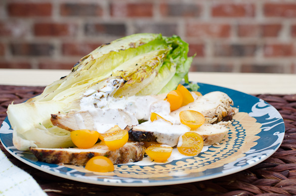Plate of chicken salad with ranch dressing and yellow tomatoes.