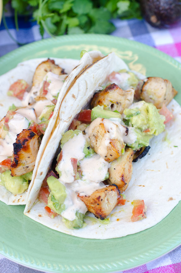 Two grilled chicken tacos on a plate.