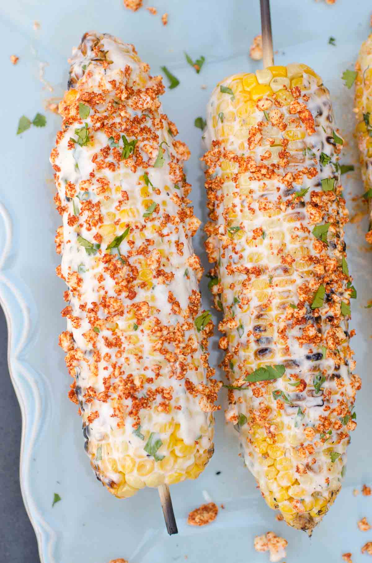 grilled corn on cob on skewers with creamy sauce