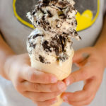 Child holding OREO ice cream cone