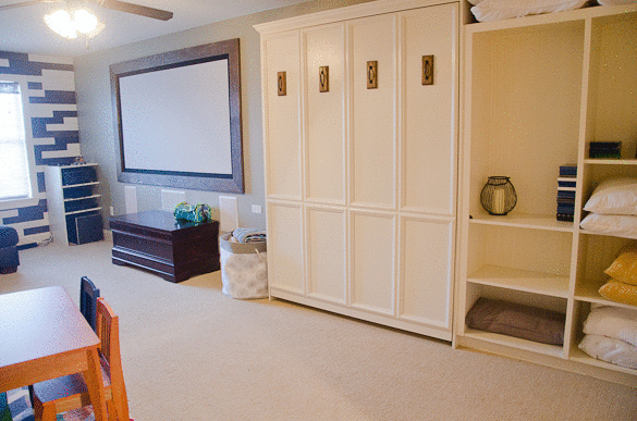 Home Tour: We use our bonus room for three uses in one! A DIY built-in murphy beds and shelves, along with a full bathroom turns this into a guest room, while it's also a theater room and a playroom!
