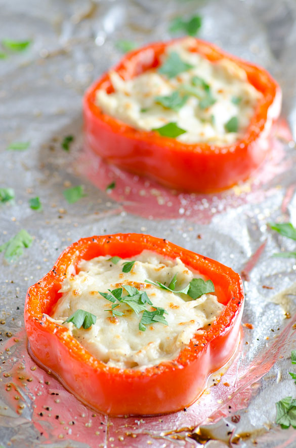 Cheese filled red pepper rings on baking pan.