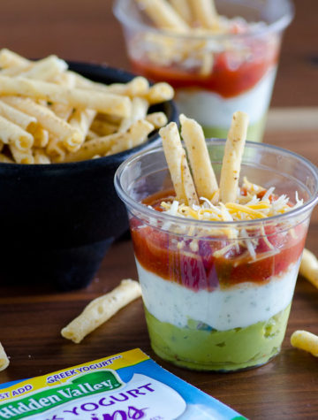 Layered Fiesta Dip with Greek Yogurt Ranch - use store-bought guacamole, salsa and Hidden Valley dry ranch mix for this very easy and convenient layered dip that's pretty, too!.