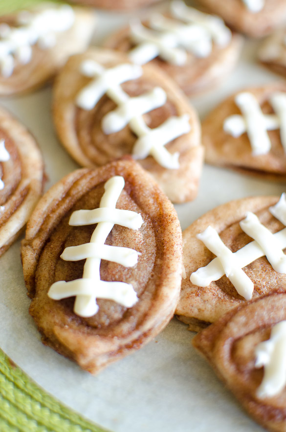Cinnamon cookies in the shape of a football with icing threads.