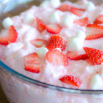 Every party, holiday or potluck meal needs this Strawberry Jell-O Fluff Salad recipe at the table. This whipped Jell-O fruit salad includes Cool Whip and fruit, and can be served as dessert or a side dish. Strawberry Jell-O Fluff Salad gives a perfect fruity fluffy delicious bite!