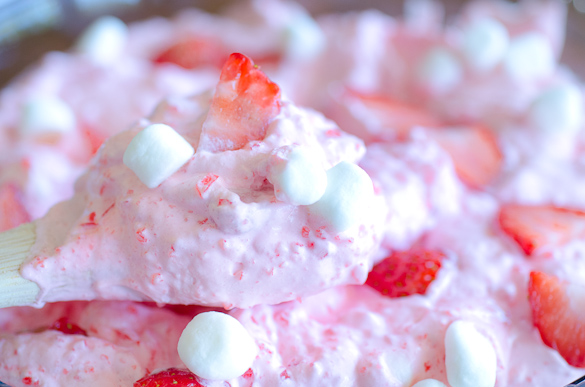 Every party, holiday or potluck meal needs this Strawberry Jell-O Fluff Salad recipe at the table. This whipped Jell-O fruit salad includes Cool Whip and fruit, and can be served as dessert or a side dish. Strawberry Jell-O Fluff Salad gives a perfect fruity fluffy delicious bite!