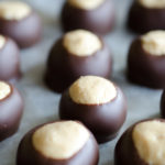 This simple Peanut Butter Buckeyes recipe is a classic no-bake Christmas candy that can be enjoyed year-round. These chocolate-dipped peanut butter balls are rich and creamy and easy to make at home! Keep the buckeyes in the freezer to make them last even longer!