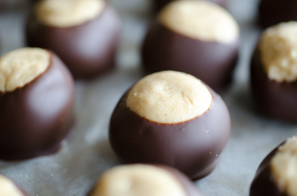 This simple Peanut Butter Buckeyes recipe is a classic no-bake Christmas candy that can be enjoyed year-round. These chocolate-dipped peanut butter balls are rich and creamy and easy to make at home! Store the Buckeyes in the freezer to make them last even longer!