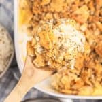 poppy seed chicken casserole scooped with wooden spoon
