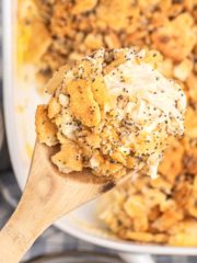 poppy seed chicken casserole scooped with wooden spoon