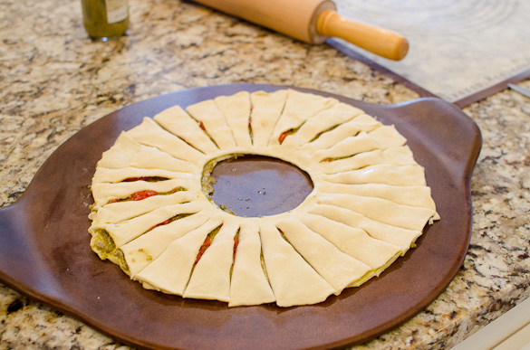 This Puff Pastry Pesto Wreath is the perfect easy appetizer for your holiday party. This delicious pastry wreath looks fancy, but it's quick and takes only 10 minutes to put together.