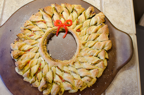 This Puff Pastry Pesto Wreath is the perfect easy appetizer for your holiday party. This delicious pastry wreath looks fancy, but it's quick and takes only 10 minutes to put together.